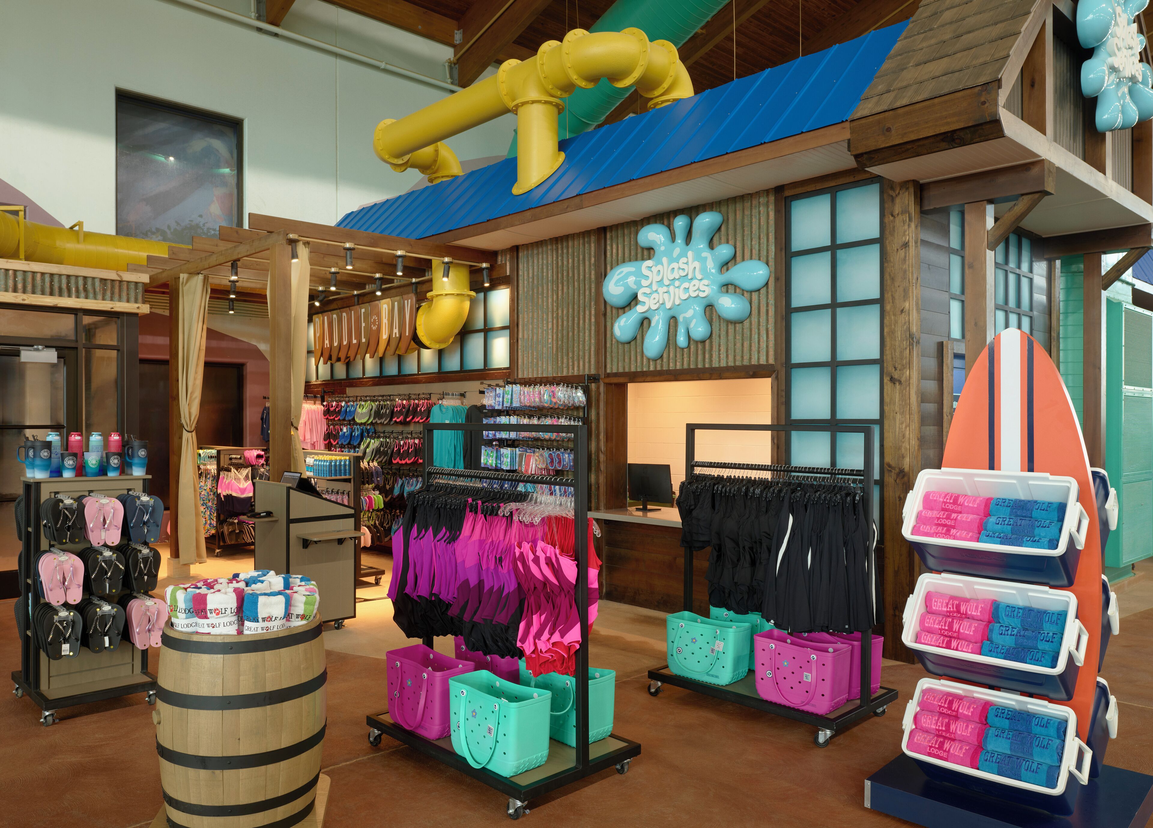 A store with various items on display including flip-flops, swimsuits, and beach bags.