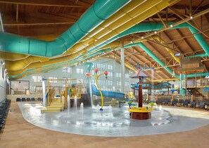 An indoor water park with slides, water features, and seating areas. - Great Wolf Lodge Webster (Webster)