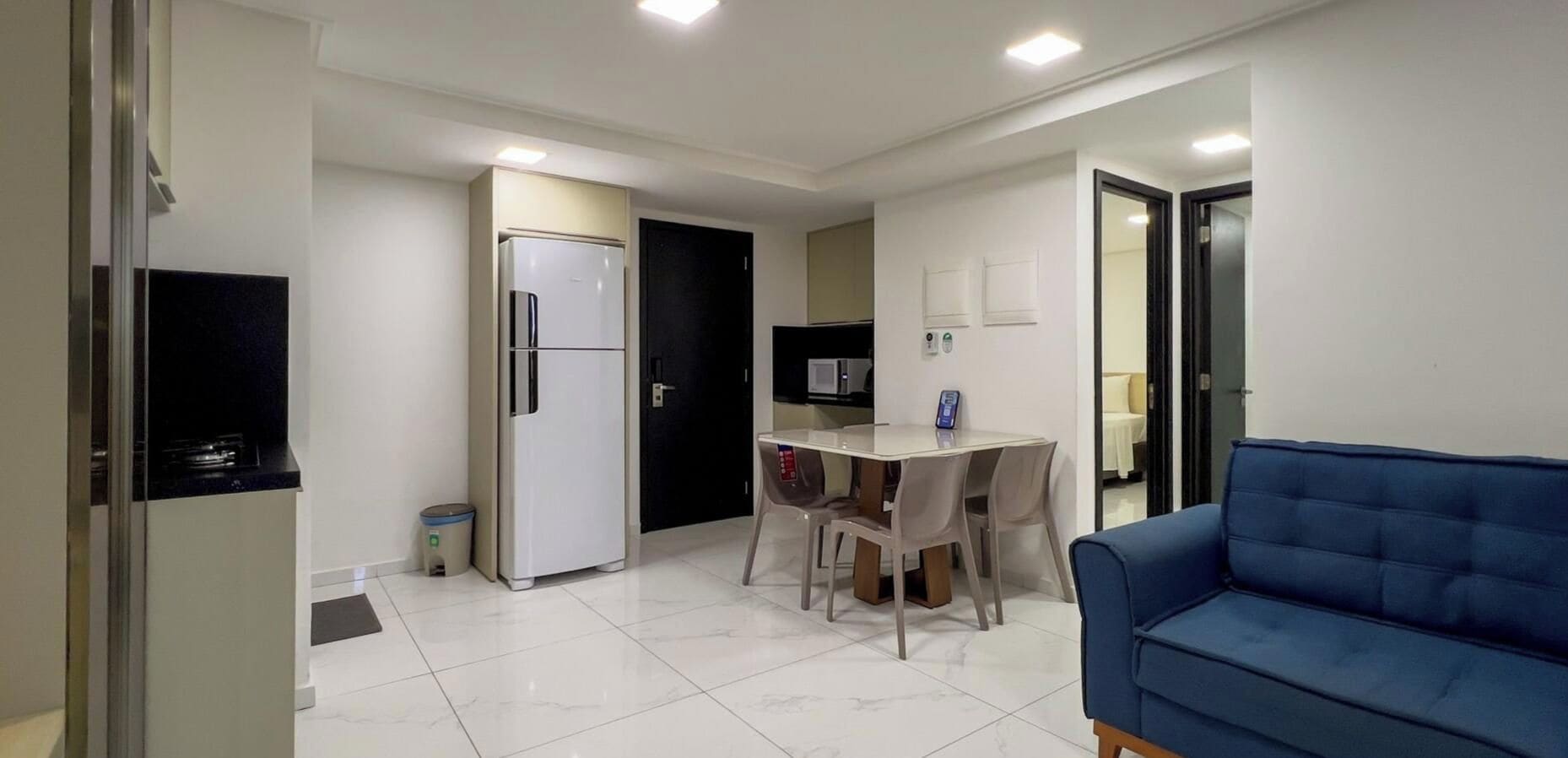 A compact living space with a kitchenette, a dining area, and a seating area.