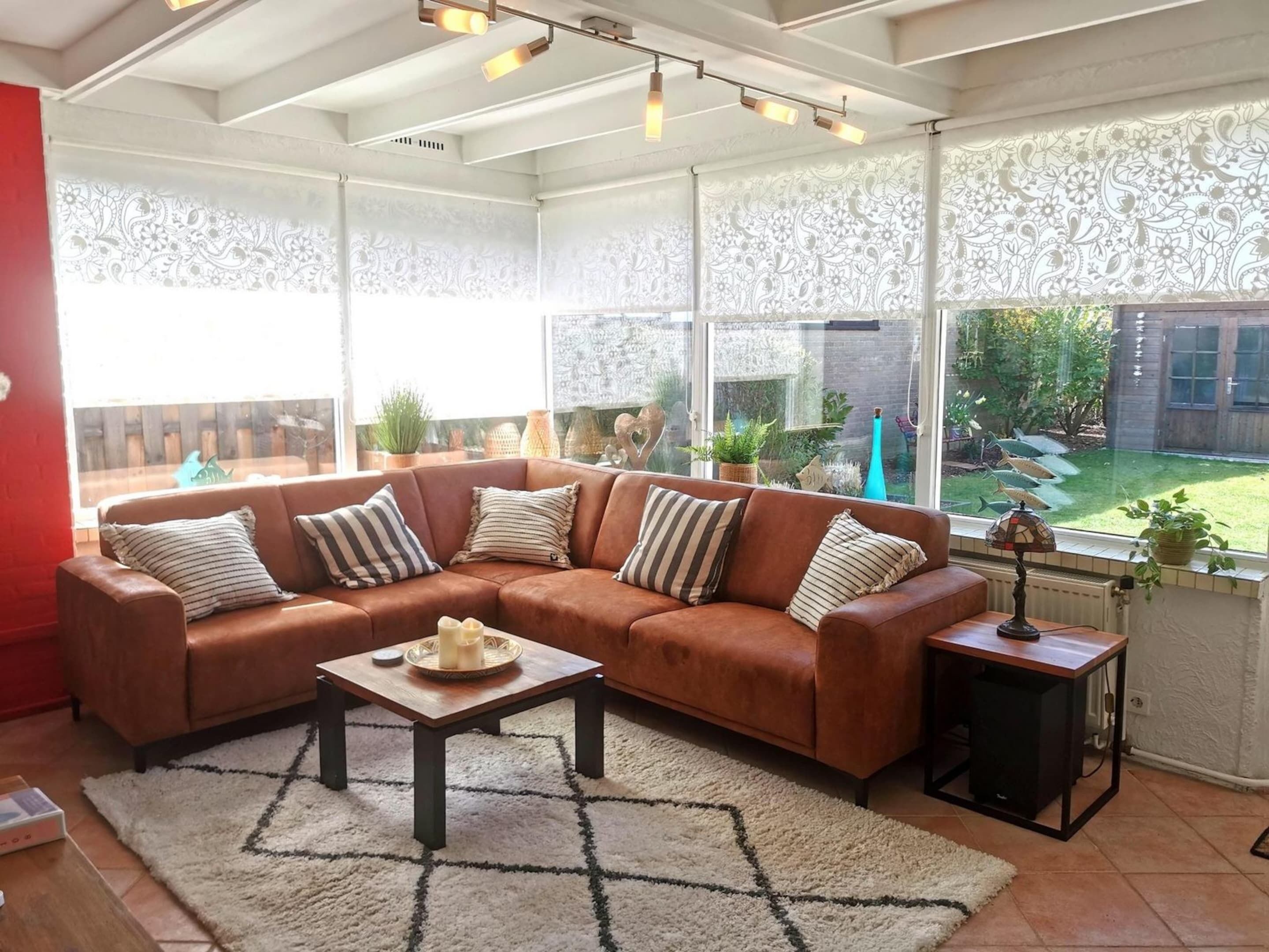 A cozy living room with a brown sectional sofa, a coffee table, and a patterned rug.