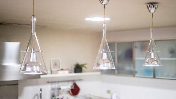 A modern kitchen with pendant lights, a sink, and a stove. - Ludo's House (Napoli)
