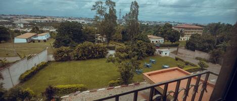 A residential area with a well-maintained lawn, a small pool, and a few trees.