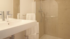 A bathroom with a large sink, mirror, and shower. - 2-bedroom loft in the heart of Paris (Paris)