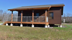 A wooden cabin with a balcony, a small attached room, and a clear sky in the background. - Johnson's Shut-ins State Park (Middle Brook)