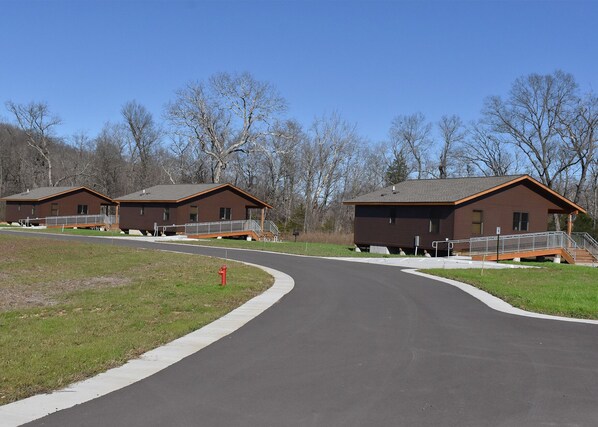 A campground with two cabins, each with a porch and a staircase leading to the entrance. - Johnson's Shut-ins State Park (Middle Brook)