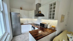 A compact kitchen with a built-in stove, a microwave, and a sink.