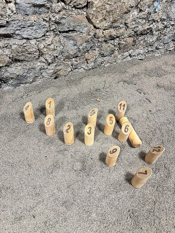 Wooden numbered blocks arranged on a textured surface.