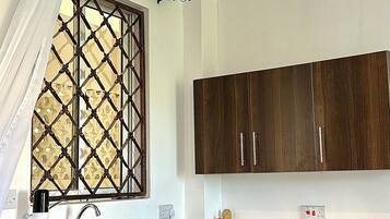 Fridge, microwave, electric kettle, cookware/dishes/utensils