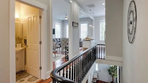 A spacious interior with a staircase, a kitchen area, and a living room.