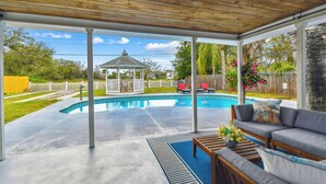 A covered patio with a pool, outdoor furniture, and a gazebo. - Tropical Oasis •Pet-Friendly + Pool Clearwater (Largo)
