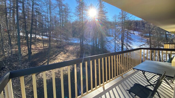A deck with a view of a forest and a body of water. - 06CO : beautiful apartment at the foot of the slopes with balcony (Guillaumes)