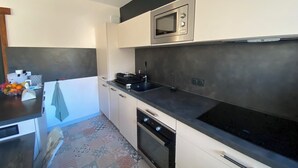 A modern kitchen with a microwave, stove, and dishwasher. - 06CO : beautiful apartment at the foot of the slopes with balcony (Guillaumes)