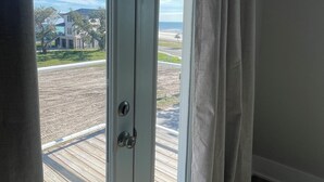A room with a sliding glass door leading to a wooden deck.