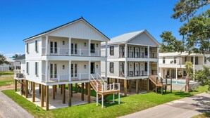 A beachfront property with multiple levels, outdoor decks, and a swimming pool.