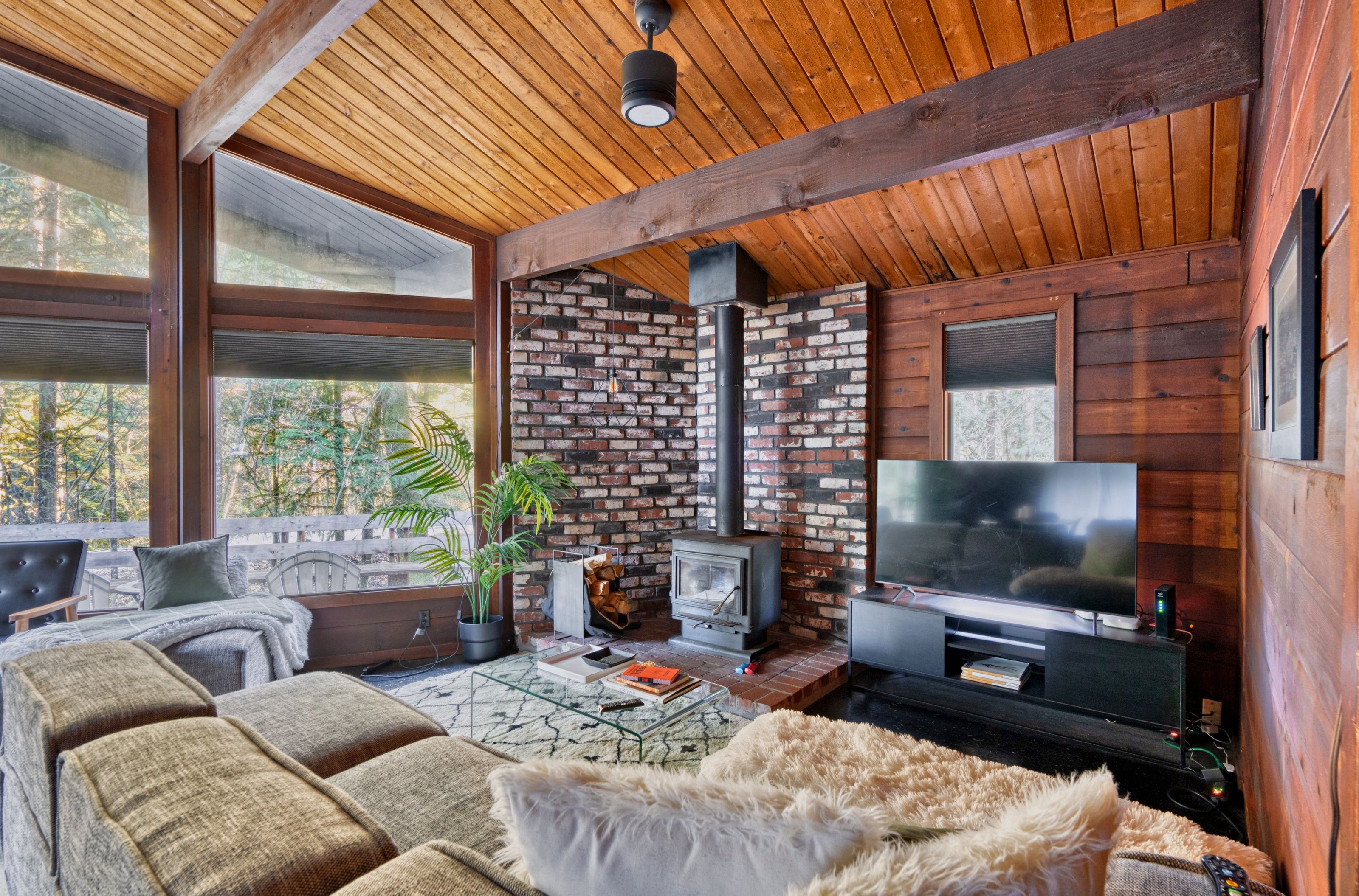 Een gezellige woonkamer met een open haard, een televisie en comfortabele zitplaatsen.