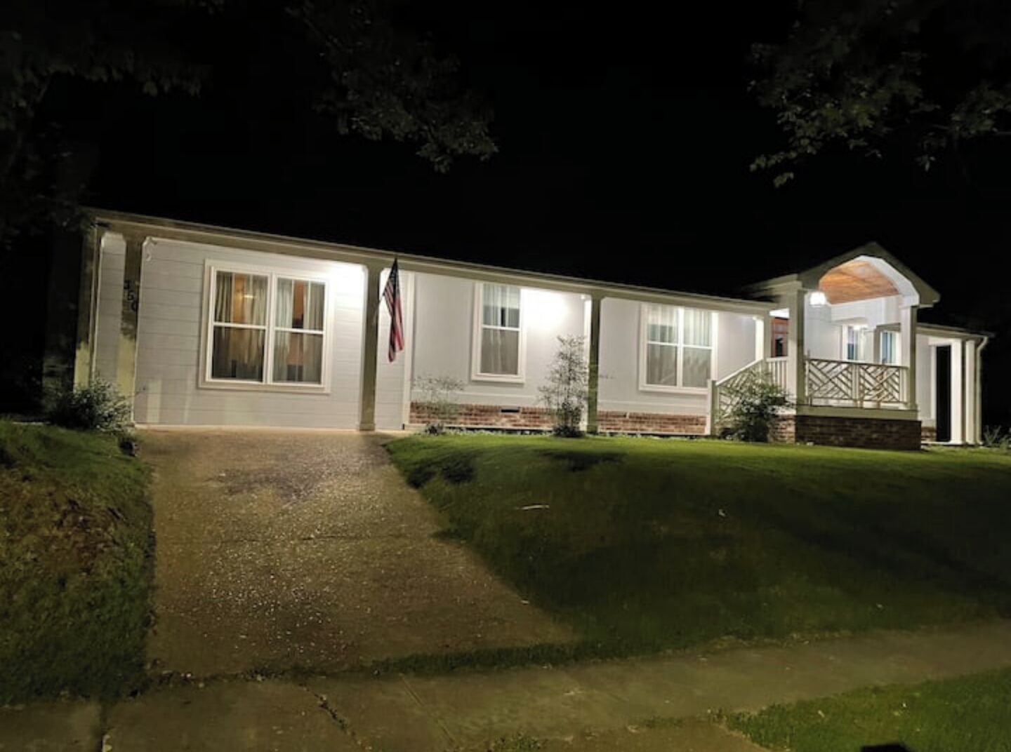 A two-story house with a front porch and a small attached garage.