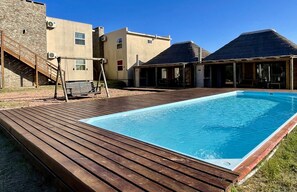 Enjoy a refreshing swim in the resort's rectangular pool surrounded by a wooden deck.