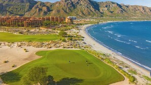 A golf course with a beach and mountains in the background. - 2 bed, 3 bath, full kitchen, in-room laundry, balcony at tranquil golf resort  (Ensenada Blanca)