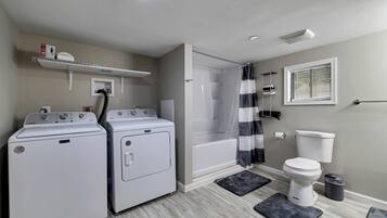 Een douche, handdoeken, zeep, toiletpapier