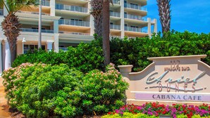 A sign for the Ariel Dunes Cabana Cafe with a landscaped garden in front. - Life is Better at the Beach!  Charming 3 bedroom, 3 bath condo at Ariel Dunes 1 (Miramar Beach)