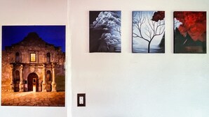 A wall with four framed artworks depicting architectural and natural scenes. - Craven Cottage Studio at Hillside with Wifi, AC & 4K Smart TV (El Paso)