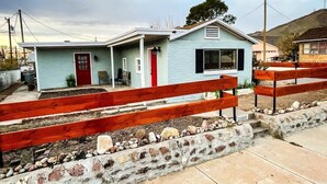 A single-story house with a red door and a small porch. - Craven Cottage Studio at Hillside with Wifi, AC & 4K Smart TV (El Paso)