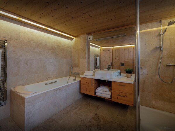A modern bathroom with a freestanding bathtub, a vanity with a mirror, and a shower area. - Chalet San Marco - mountain luxury stay for 6 - OVO Network (La Clusaz)