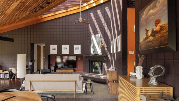 A modern interior with a wooden ceiling, a fireplace, a sofa, and a dining area. - Architects Dream Home | Secluded Retreat | 30 Day (Golden)