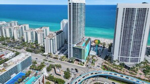 A high-rise hotel with a pool and beach view, surrounded by other buildings and a clear blue sky. - Best View in Lyfe Hollywood Beach (Hollywood)