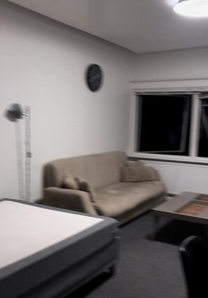 Relax in this serene space with a comfortable sofa and a convenient table for your needs.