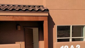 A building with a flat facade, a door, and a window with the number 19A2.