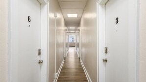 A corridor with doors numbered 3 and 6, leading to rooms. - Cozy Studio Near Children’s Hospital, Kitchen & Laundry (Columbus)