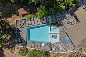 An aerial view of a backyard with a swimming pool, patio furniture, and a small deck area. - Cozy Oasis in Oakley with Basketball court,pool (Los Angeles)