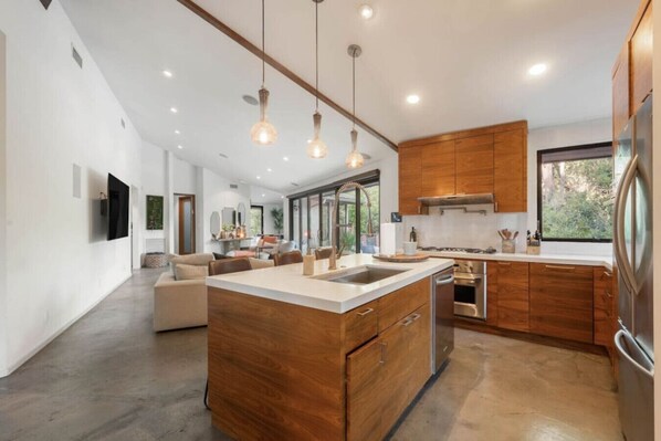 Fridge, dishwasher, coffee/tea maker, cookware/dishes/utensils