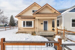 Stunning two-story home with a cozy front porch and inviting entrance.