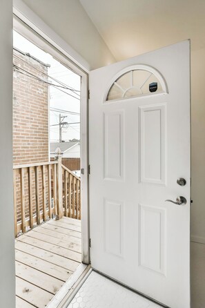 A white door with a glass panel and a small window above it.