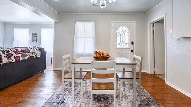 A dining area with a table, chairs, and a decorative bowl on the table. - Benedictine Theme 2br 1ba (Atchison)