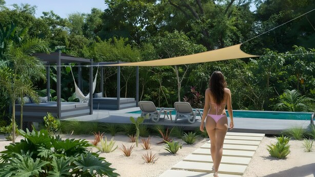 Una mujer caminando hacia una zona de piscina con una hamaca y sillones de descanso.