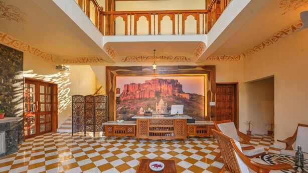 A checkered floor, wooden furniture, a decorative wall, and a chandelier. - Tryambakam Villa (Bhilwara)