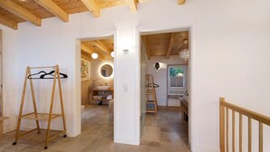 A hallway with a wooden rack, a bathroom with a sink and mirror, and a staircase. - Holiday Home 'Mit Panoramablick' with Mountain View, Shared Terrace and Wi-Fi (Gernrode)