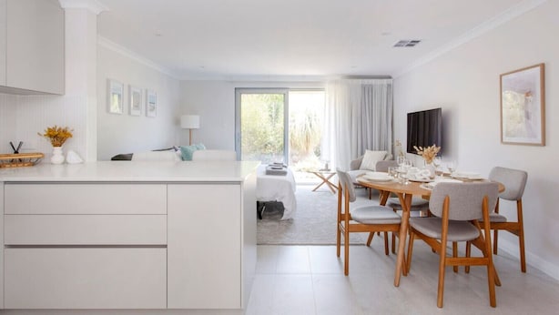 A modern, well-lit room with a kitchen, dining area, and a large window. - Maylands Riverside City Retreat (Maylands)