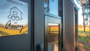 A door with a sign stating 'MANAGED BY TINY Away' and a keypad lock. - Coleslea by Tiny Away (Leeton)