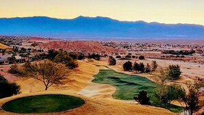 A golf course with a desert landscape, mountains in the background, and sparse vegetation. - Luxury, 4+ Bedroom, 4 Bath Home on Golf Course with the Best View in Mesquite! (Mesquite)