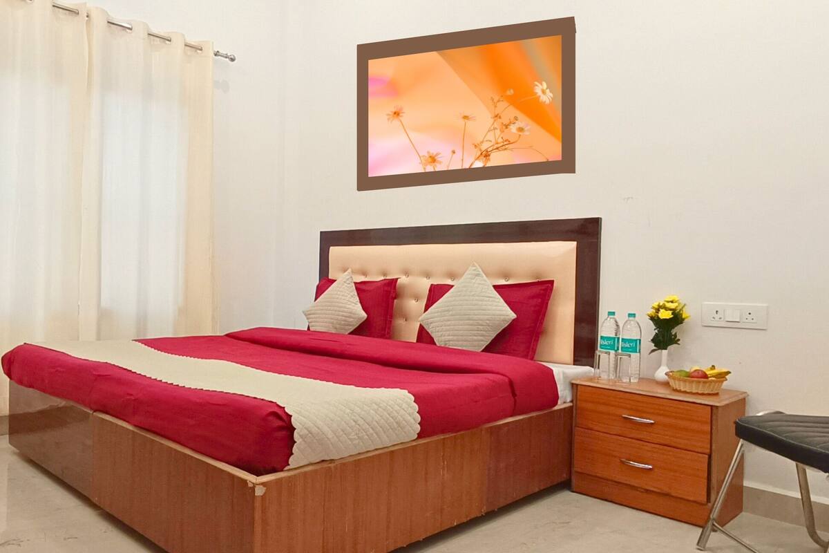 A neatly arranged bedroom with a bed, bedside table, and a chair.