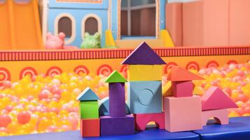 A play area with colorful building blocks and a ball pit.