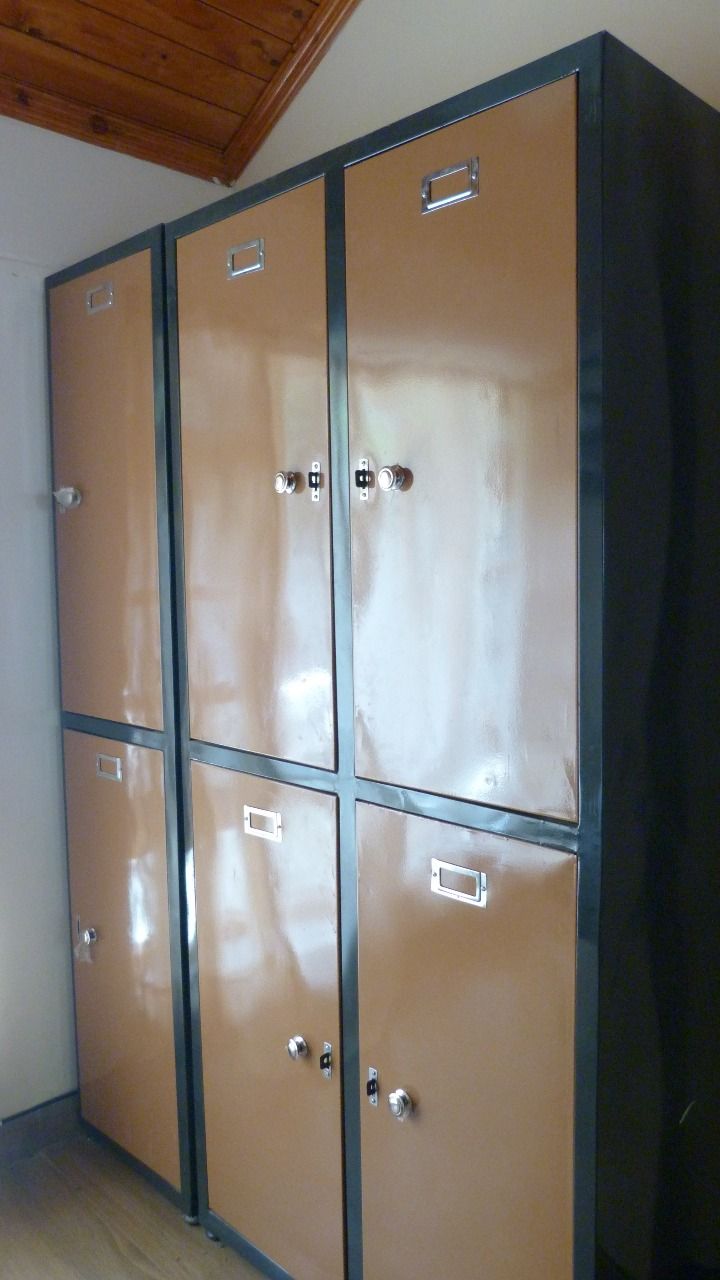 A set of six large, metallic lockers with handles, arranged in two columns and three rows.