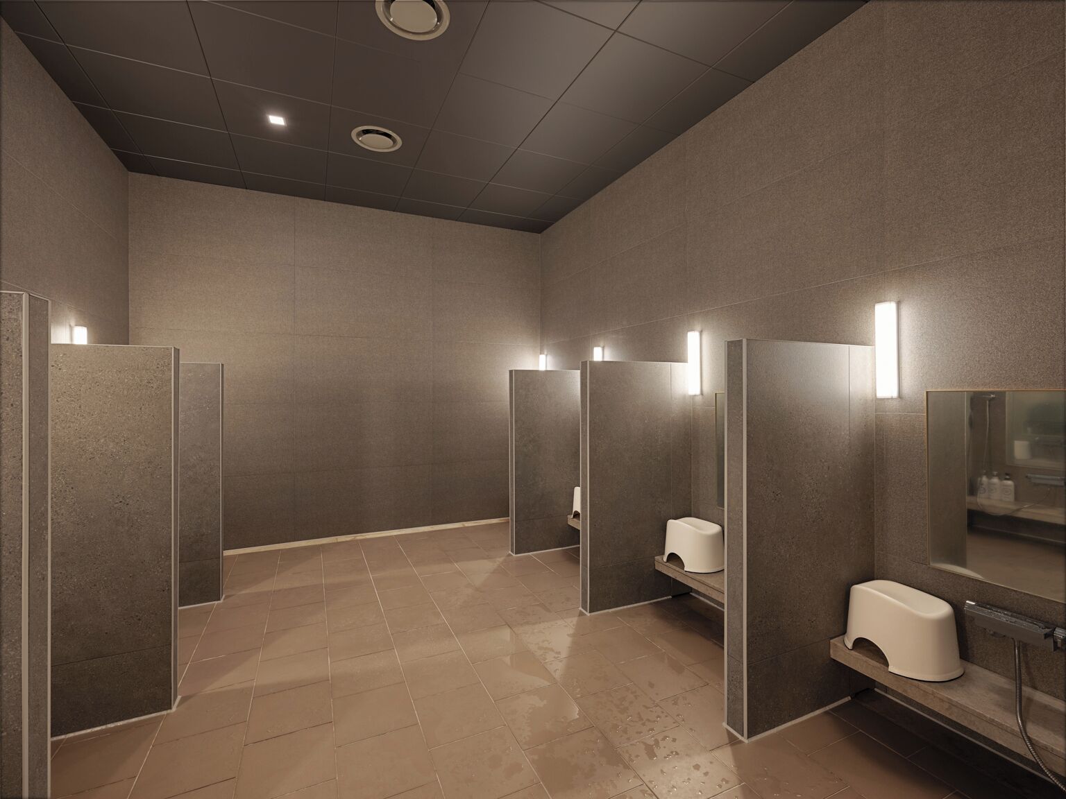 Un bagno moderno con cabine separate, un asciugamani ad aria e uno specchio.