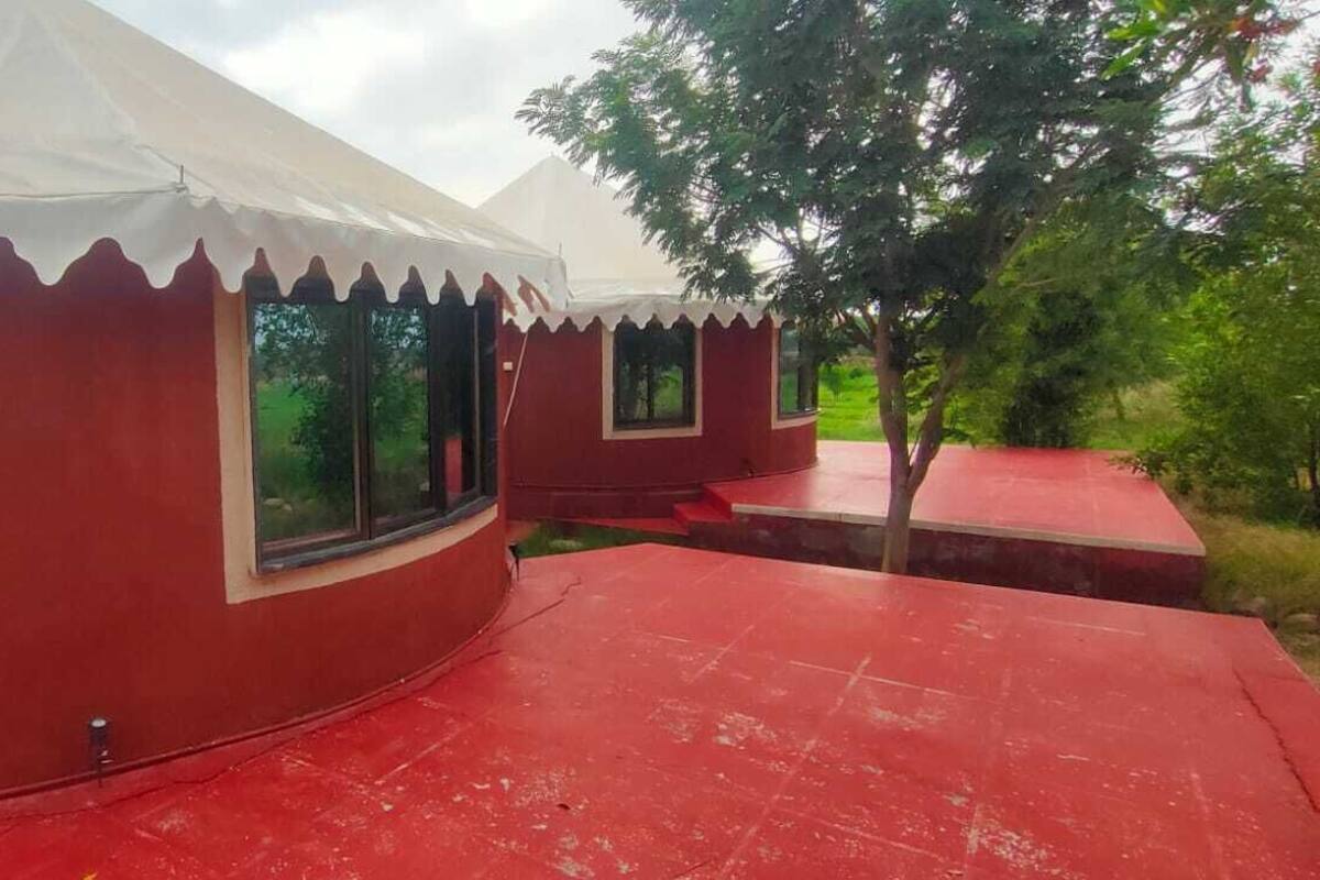 A red and white tent structure with large windows and a red roof.