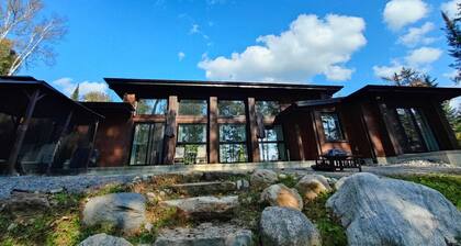 Expansive Lakefront modern retreat nestled by nature, huge windows ,4 bedroom