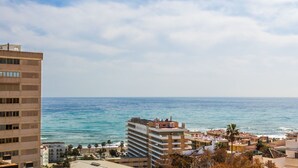 A coastal cityscape with a prominent high-rise building and a beachfront area. - Casa Martin - Sea Views (Torremolinos)